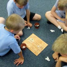 Children playing history games in classroom workshop